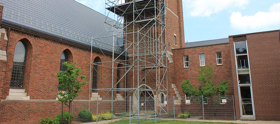 Image of our renovation service. Picture of a scaffolding outside of an old church being fixed.